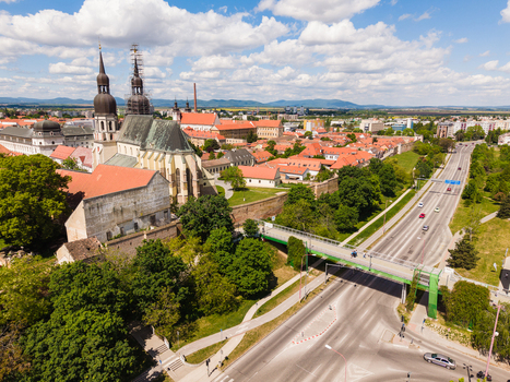 Aerial view of St. Nicholas Basilica with its twin towers historic red rooftops and lush green trees under a cloudy sky Trnava Trnava Region Slovakia. Aerial view of St. Nicholas Basilica with its twin towers historic red rooftops and lush green trees under a cloudy sky Trnava Trnava Region Slovakia.