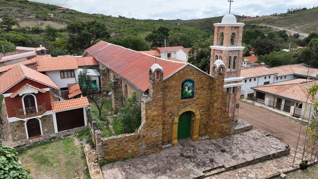 Aerial view of the historic stone church in Torotoro with its distinctive bell tower red tiled roofs and surrounding village buildings in Torotoro Potosi Department Bolivia.