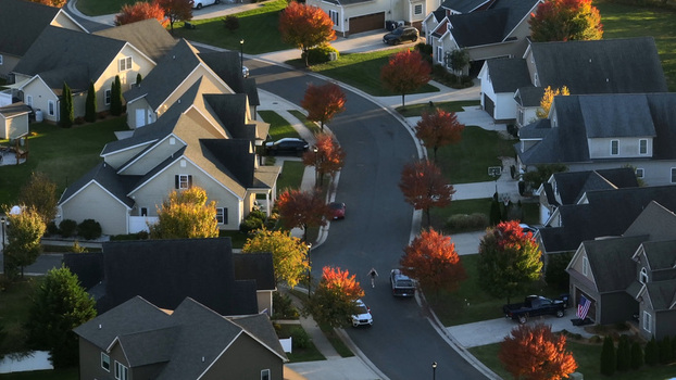 Aerial view of a quiet residential neighborhood in Lynchburg Virginia United States featuring suburban houses with autumn foliage and a winding street. Aerial view of a quiet residential neighborhood in Lynchburg Virginia United States featuring suburban houses with autumn foliage and a winding street.