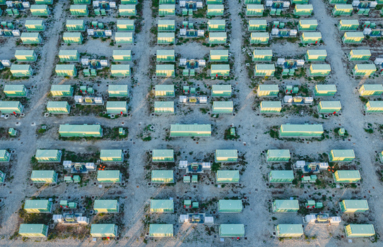 Aerial view of a large battery energy storage facility featuring rows of containerized power units and electrical equipment in Trino Piedmont Italy.