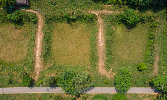 Aerial view of agricultural land with dirt paths and green fields in Punjab Pakistan. Aerial view of agricultural land with dirt paths and green fields in Punjab Pakistan.