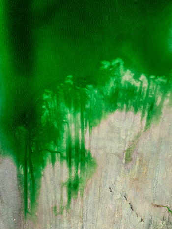 Aerial view of vibrant green phosphor deposits spreading across light colored sandy terrain in Andalusia Spain. Aerial view of vibrant green phosphor deposits spreading across light colored sandy terrain in Andalusia Spain.