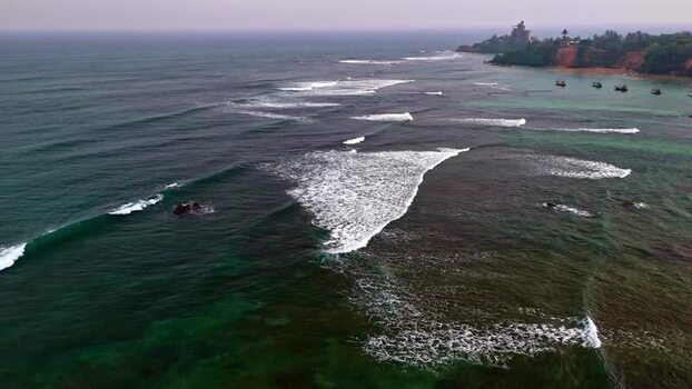 Aerial view of the coastline and ocean waves in Sri Lanka.