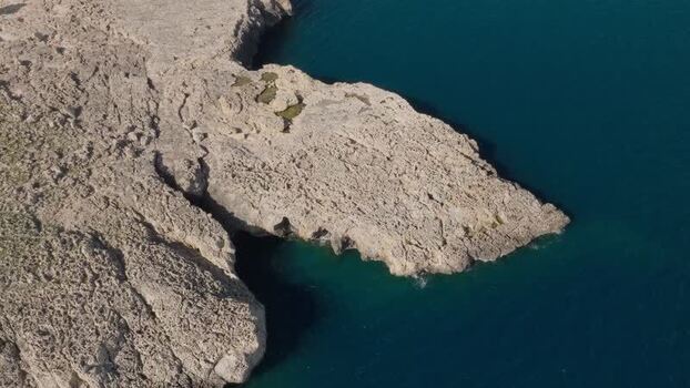 Aerial view of the rugged limestone cliffs of Plemmirio Italy.