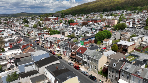 Aerial view of the dense residential neighborhood with rows of historic houses streets and cars in Reading Pennsylvania United States. Aerial view of the dense residential neighborhood with rows of historic houses streets and cars in Reading Pennsylvania United States.