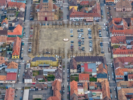 Aerial view of the Vauban era fortress town with its grid like layout and central Place d Armes a stark contrast of red tiled roofs and orderly streets Neuf Brisach Grand Est France.