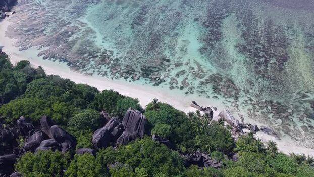 Aerial view of Anse Reunion beach and granite boulders Seychelles.