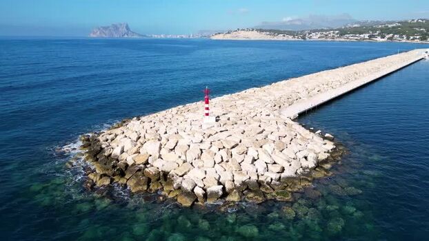 Aerial view of the breakwater and lighthouse in Moraira Spain.