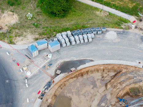 Aerial view of a new road construction site with stacks of paving stones excavated earth and construction materials in Riga Latvia. Aerial view of a new road construction site with stacks of paving stones excavated earth and construction materials in Riga Latvia.