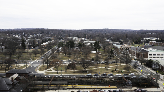 Aerial view of the town of Summit featuring a train station roads with traffic residential buildings and bare trees under an overcast sky in Summit New Jersey United States. Aerial view of the town of Summit featuring a train station roads with traffic residential buildings and bare trees under an overcast sky in Summit New Jersey United States.