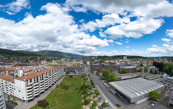 Aerial view of Esplanade Kongresshaus 11 with modern residential buildings a green park and distant mountains under a cloudy sky in Biel Bienne Canton of Bern Switzerland. Aerial view of Esplanade Kongresshaus 11 with modern residential buildings a green park and distant mountains under a cloudy sky in Biel Bienne Canton of Bern Switzerland.