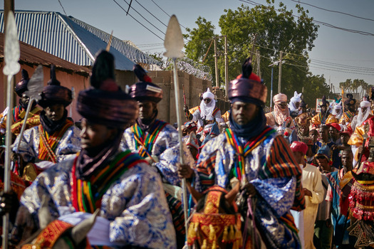 Zaria city Nigerian 22 March 2026 View of regal figures in vibrant patterned robes and towering turbans carrying spears march in a procession. Zaria city Nigerian 22 March 2026 View of regal figures in vibrant patterned robes and towering turbans carrying spears march in a procession.