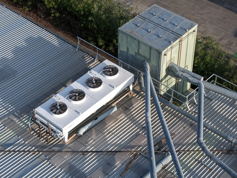Melbourne VIC Australia 22 September 2026 Aerial view of an industrial rooftop in Kilsyth featuring a large HVAC cooling unit with multiple fans and ventilation pipes. Melbourne VIC Australia 22 September 2026 Aerial view of an industrial rooftop in Kilsyth featuring a large HVAC cooling unit with multiple fans and ventilation pipes.