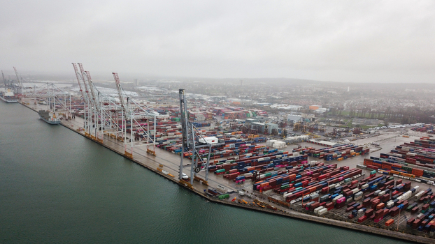 Aerial view of Southampton Port with numerous shipping containers and large cranes along the waterfront in Southampton United Kingdom. Aerial view of Southampton Port with numerous shipping containers and large cranes along the waterfront in Southampton United Kingdom.