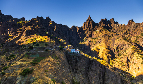 Aerial view of Santo Antao featuring rugged mountain peaks terraced agricultural fields and small buildings in Alto Mira Porto Novo Cabo Verde.
