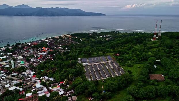 Aerial view of solar farm near coastal village in Bali Indonesia.