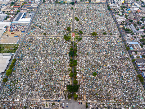 Aerial view of Maximo Gomez National Cemetery with its dense grid of graves pathways and surrounding urban landscape in Santo Domingo Distrito Nacional Dominican Republic. Aerial view of Maximo Gomez National Cemetery with its dense grid of graves pathways and surrounding urban landscape in Santo Domingo Distrito Nacional Dominican Republic.