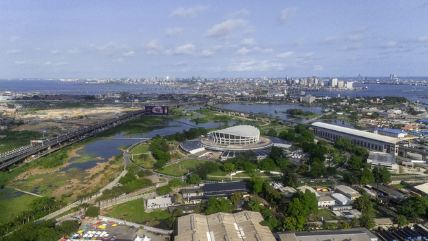 Aerial view of the Wole Soyinka Centre for Culture and Creative Arts National Theatre Nigeria surrounded by greenery and the city skyline in Lagos Lagos Nigeria. Aerial view of the Wole Soyinka Centre for Culture and Creative Arts National Theatre Nigeria surrounded by greenery and the city skyline in Lagos Lagos Nigeria.
