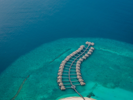 Aerial view of overwater bungalows stretching into the turquoise sea a serene escape in paradise Hoarafushi Maldives. Aerial view of overwater bungalows stretching into the turquoise sea a serene escape in paradise Hoarafushi Maldives.