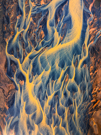 Aerial view of a braided river system with intricate patterns of sediment laden water and dark volcanic sand in Iceland. Aerial view of a braided river system with intricate patterns of sediment laden water and dark volcanic sand in Iceland.