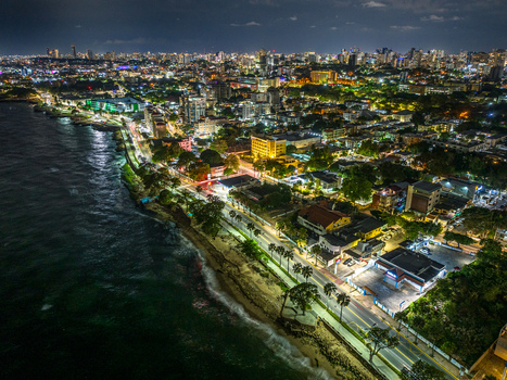 Aerial view of the illuminated Santo Domingo Malecon coastline at night featuring the city skyline and Caribbean Sea in Santo Domingo Distrito Nacional Dominican Republic. Aerial view of the illuminated Santo Domingo Malecon coastline at night featuring the city skyline and Caribbean Sea in Santo Domingo Distrito Nacional Dominican Republic.