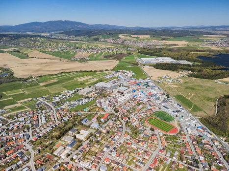 Aerial view of the town of Namestovo with residential areas a football stadium and industrial buildings surrounded by rolling green hills Namestovo Zilina Region Slovakia. Aerial view of the town of Namestovo with residential areas a football stadium and industrial buildings surrounded by rolling green hills Namestovo Zilina Region Slovakia.