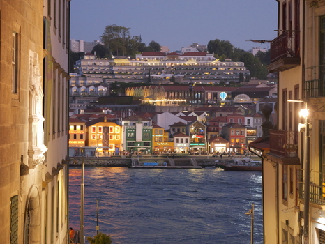 View of the illuminated colorful buildings along the Douro River in the historic Ribeira district at twilight in Porto Porto District Portugal. View of the illuminated colorful buildings along the Douro River in the historic Ribeira district at twilight in Porto Porto District Portugal.