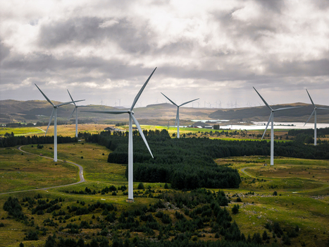 Aerial view of the Hog Jaeren wind farm featuring multiple wind turbines set against a landscape of green fields coniferous forests and a cloudy sky in Ha Municipality Rogaland Norway. Aerial view of the Hog Jaeren wind farm featuring multiple wind turbines set against a landscape of green fields coniferous forests and a cloudy sky in Ha Municipality Rogaland Norway.