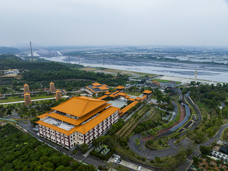 Aerial view of Fo Guang Shan Buddha Museum with its distinctive orange roofs pagodas and surrounding lush gardens near the Gaoping River in Kaohsiung Taiwan. Aerial view of Fo Guang Shan Buddha Museum with its distinctive orange roofs pagodas and surrounding lush gardens near the Gaoping River in Kaohsiung Taiwan.