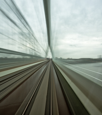 View of a train moving across a bridge with motion blur effect over the urban landscape in Utrecht Utrecht Netherlands.