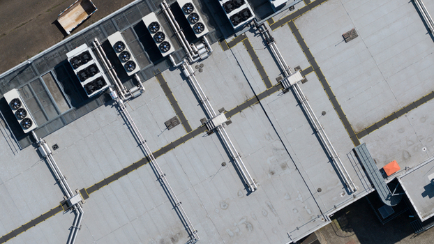 Aerial view of industrial building rooftop featuring multiple HVAC ventilation units and metal piping systems in Nieuwegein Utrecht Netherlands. Aerial view of industrial building rooftop featuring multiple HVAC ventilation units and metal piping systems in Nieuwegein Utrecht Netherlands.