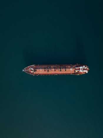 Aerial view of a large industrial tanker ship navigating deep blue waters Augusta Sicily Italy. Aerial view of a large industrial tanker ship navigating deep blue waters Augusta Sicily Italy.