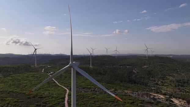 Aerial view of wind turbines on green hills in Portugal. Aerial view of wind turbines on green hills in Portugal.