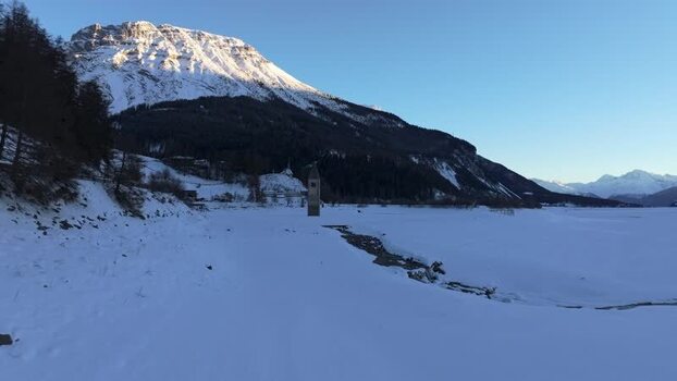 Aerial view of the historic sunken bell tower in a frozen lake Italy. Aerial view of the historic sunken bell tower in a frozen lake Italy.