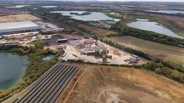 Aerial view of industrial facility and solar farm United Kingdom.