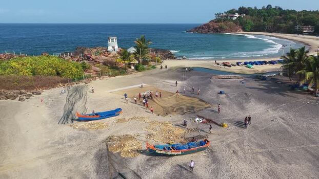 Aerial view of fishermen with boats on the beach in Kovalam India. Aerial view of fishermen with boats on the beach in Kovalam India.