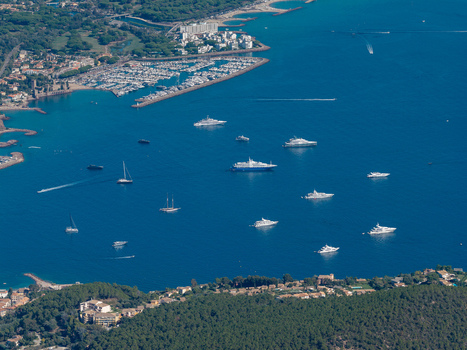 Aerial view of Le Trayas with numerous luxury yachts and sailboats anchored in the deep blue bay near the marina and coastal forest in Saint Raphael Provence Alpes Cote d Azur France. Aerial view of Le Trayas with numerous luxury yachts and sailboats anchored in the deep blue bay near the marina and coastal forest in Saint Raphael Provence Alpes Cote d Azur France.
