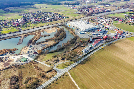 Aerial view of the residential houses industrial zone and the Main Danube Canal flowing through the rural landscape of Buttenheim Bavaria Germany. Aerial view of the residential houses industrial zone and the Main Danube Canal flowing through the rural landscape of Buttenheim Bavaria Germany.