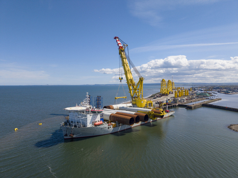 Edinburgh United Kingdom 06 May 2026 Aerial view of a heavy lift vessel at the Port of Leith carrying large offshore wind turbine foundations under a clear blue sky. Edinburgh United Kingdom 06 May 2026 Aerial view of a heavy lift vessel at the Port of Leith carrying large offshore wind turbine foundations under a clear blue sky.