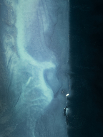 Aerial view of glacial river delta with intricate sediment patterns and dark volcanic sand coastline in Iceland. Aerial view of glacial river delta with intricate sediment patterns and dark volcanic sand coastline in Iceland.