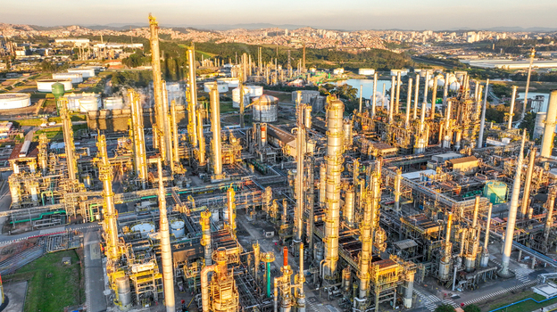 Aerial view of the large petrochemical complex with tall distillation columns storage tanks and industrial infrastructure in Santo Andre State of Sao Paulo Brazil.