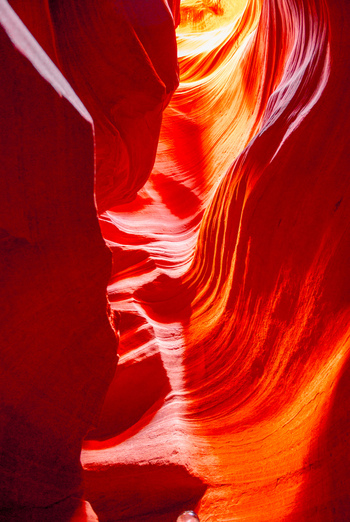 View of Antelope Canyon with smooth flowing sandstone walls displaying vibrant orange and red hues illuminated by soft natural light in Coconino County Arizona United States. View of Antelope Canyon with smooth flowing sandstone walls displaying vibrant orange and red hues illuminated by soft natural light in Coconino County Arizona United States.