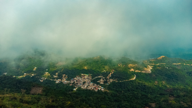 Aerial view of Mt. Gemi overlooking the village of Amedzofe nestled in the lush green mountains of the Volta Region Ghana. Aerial view of Mt. Gemi overlooking the village of Amedzofe nestled in the lush green mountains of the Volta Region Ghana.