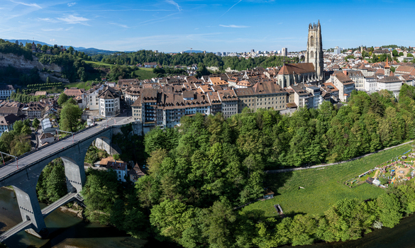 Aerial view of St Nicolas Cathedral and the historic old town with the Zaehringen Bridge over the Sarine river in Fribourg Fribourg Switzerland. Aerial view of St Nicolas Cathedral and the historic old town with the Zaehringen Bridge over the Sarine river in Fribourg Fribourg Switzerland.