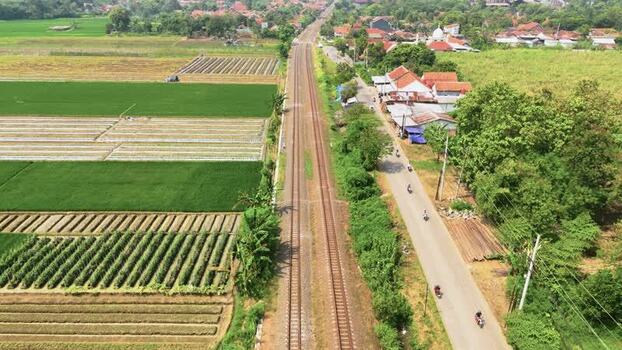 Aerial view of a railway track through rice fields Indonesia. Aerial view of a railway track through rice fields Indonesia.