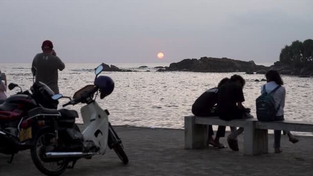 View of people watching the sunset by the sea Sri Lanka. View of people watching the sunset by the sea Sri Lanka.