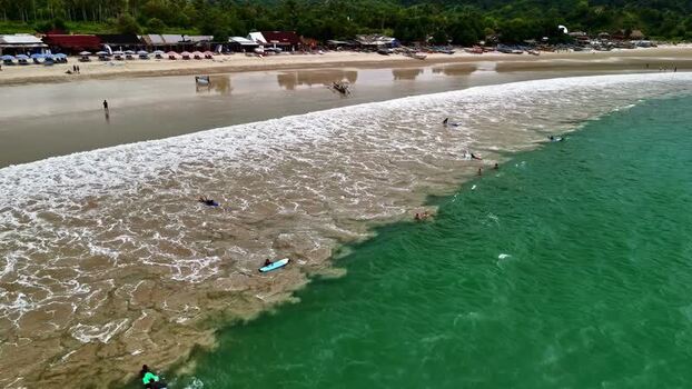 Aerial view of surfers on a beach in Bali Indonesia.