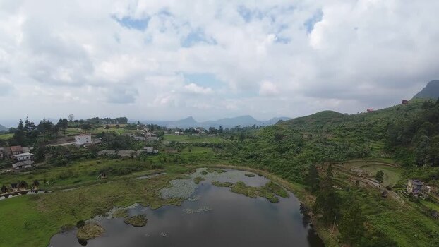 Aerial view of Rawa Gede Jonggol Lake and green hills Indonesia.