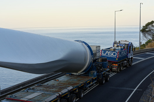Estreito da Calheta Madeira Portugal 20 September 2026 View of a wind turbine blade being transported on a heavy duty truck along a coastal road with the Atlantic Ocean in the background. Estreito da Calheta Madeira Portugal 20 September 2026 View of a wind turbine blade being transported on a heavy duty truck along a coastal road with the Atlantic Ocean in the background.