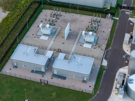 Aerial view of an advanced power substation with electrical transformers metal utility buildings and gravel grounds enclosed by fencing in Warsaw Masovian Voivodeship Poland. Aerial view of an advanced power substation with electrical transformers metal utility buildings and gravel grounds enclosed by fencing in Warsaw Masovian Voivodeship Poland.